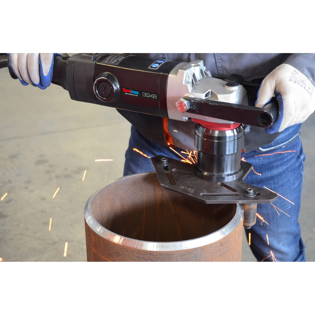 Steelmax 120V BM18 Portable Beveling Machine in use as a person bevels a metal pipe edge, sparks flying.
