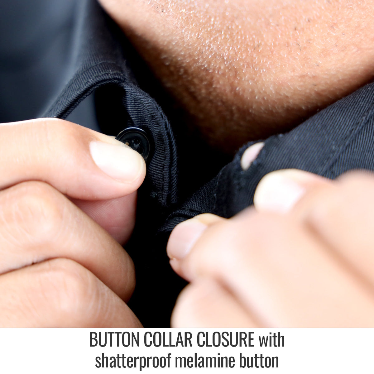 Hands buttoning a {Black Stallion Revco BSX 7oz AR/FR cotton work shirt WF3530-BK} with melamine buttons, close-up view.