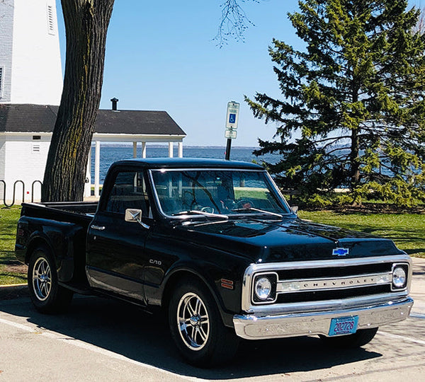 A dark blue Chevrolet truck, parked outside.